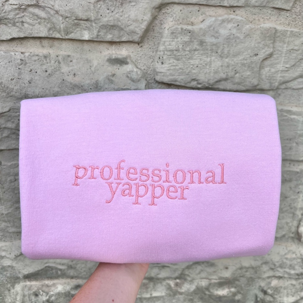 Professional Yapper Heavy Blend Crewneck Sweatshirt in light pink monochrome